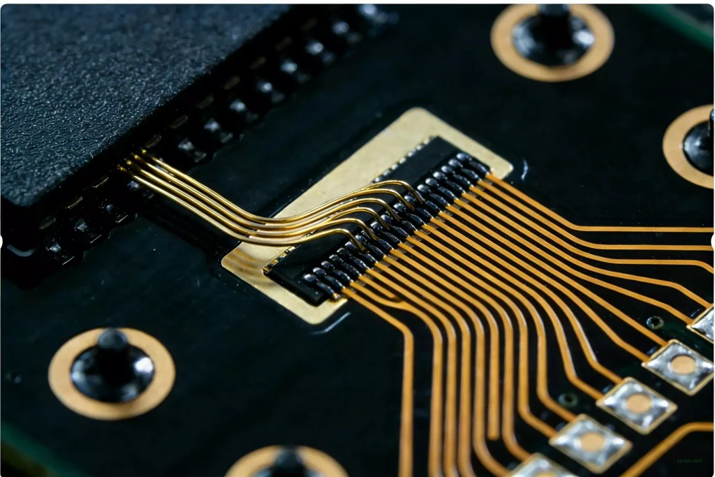 Microscopic image of a silicon chip connected to a substrate via gold wire bonding in the COB (Chip On Board) process