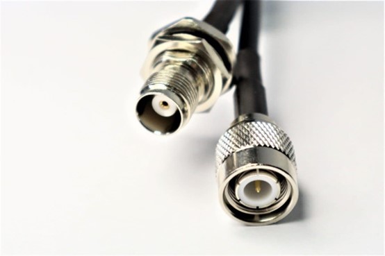 Close-up of TNC and SMA RF connectors, TNC as a bulkhead female and SMA as a male, for high-frequency RF cables