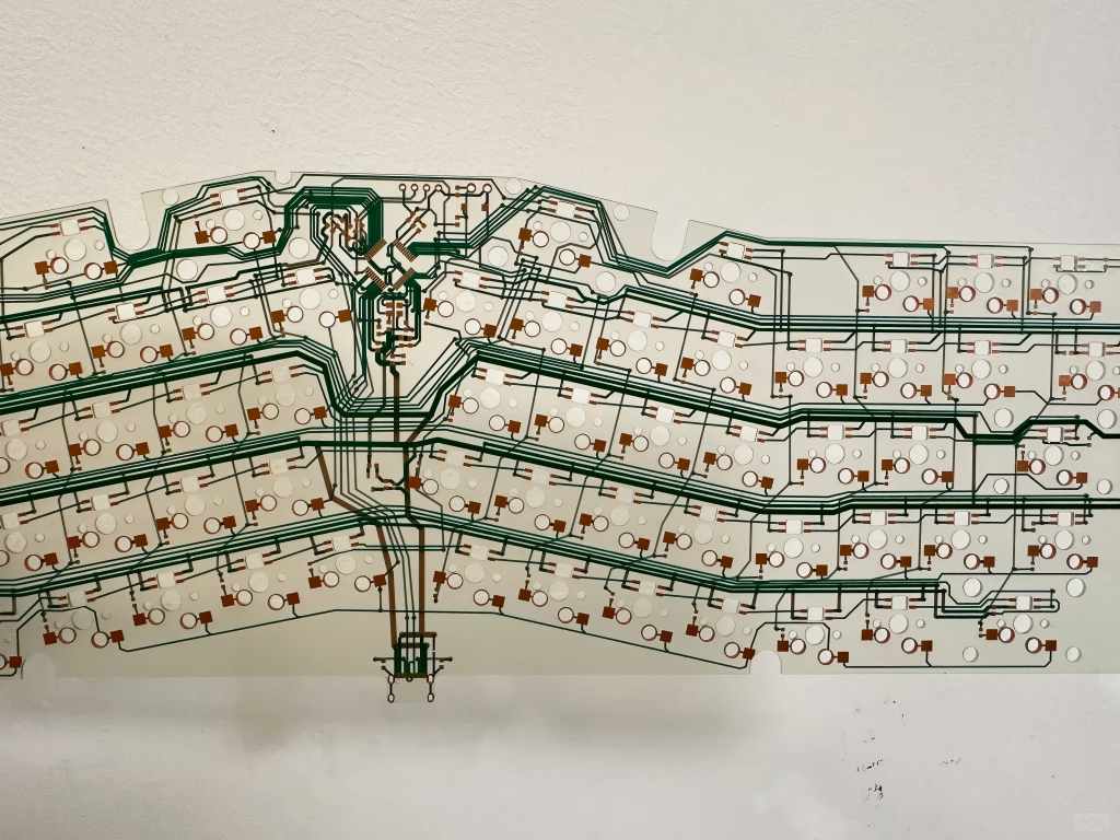 Large-area transparent FPC panel with green solder mask and copper traces, integrating dense pads and complex circuits for high-density electronic devices