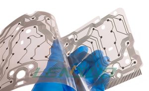 Close-up of a transparent flexible FPC being bent, featuring a transparent polyimide substrate and visible silver traces, demonstrating its high flexibility and bendability