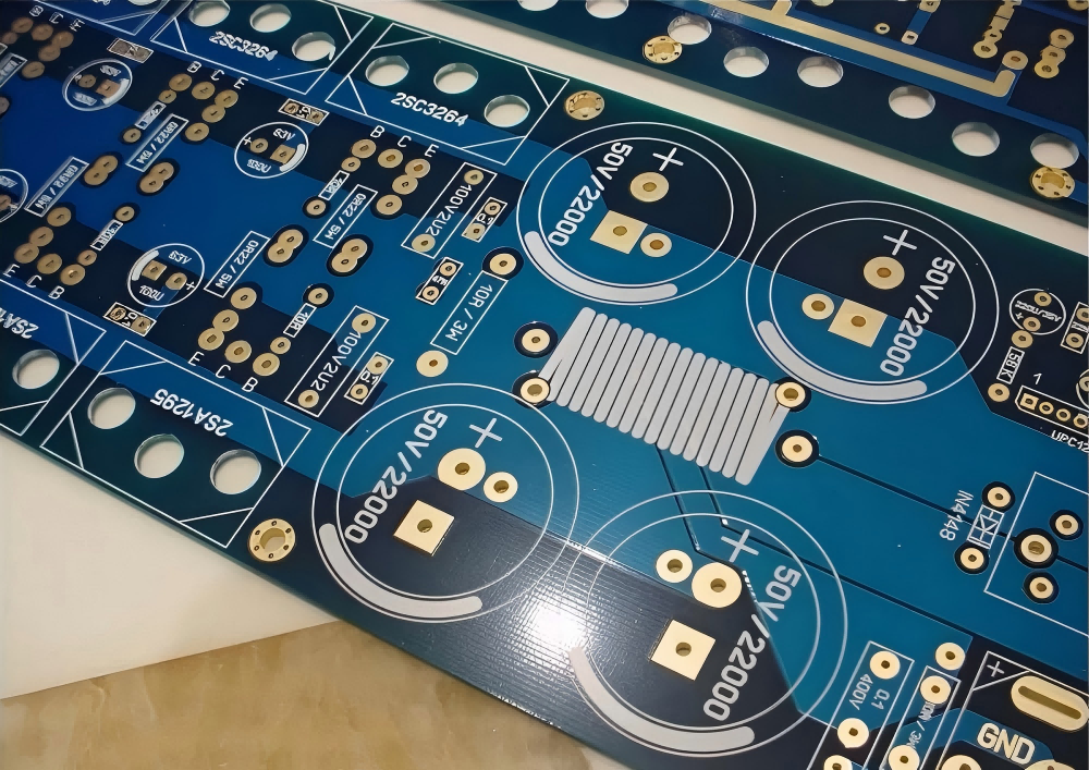 Close-up of high-quality PCB with immersion gold surface finish, showing gold-plated pads, component footprints, and circuit traces for audio power amplifier applications.