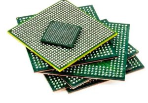 Stack of multiple BGA-packaged chips, displaying the bottom solder ball grids of different sizes for electronic assembly.