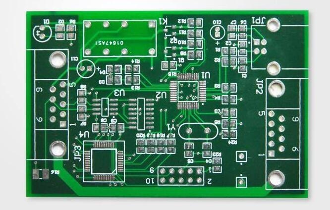 Top view of a double-sided PCB showing component footprints, traces, and through-hole pads, used for electronic circuit assembly.