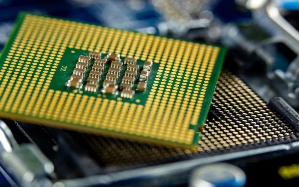 BGA packaged chip aligned with its socket on a motherboard, illustrating the soldering interface for surface-mount assembly.